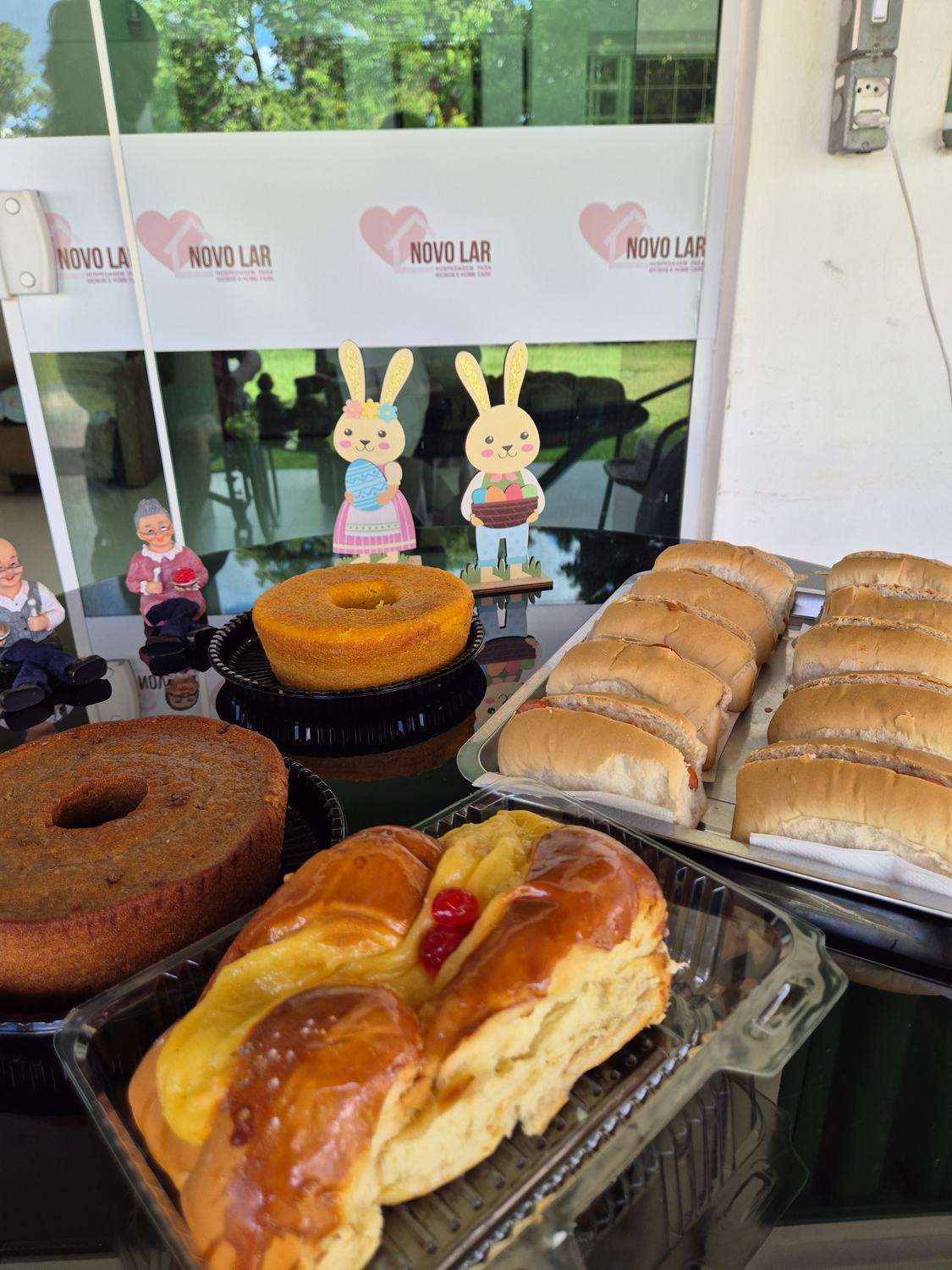 Mesa do café da tarde com pães, rosca e bolo caseiro